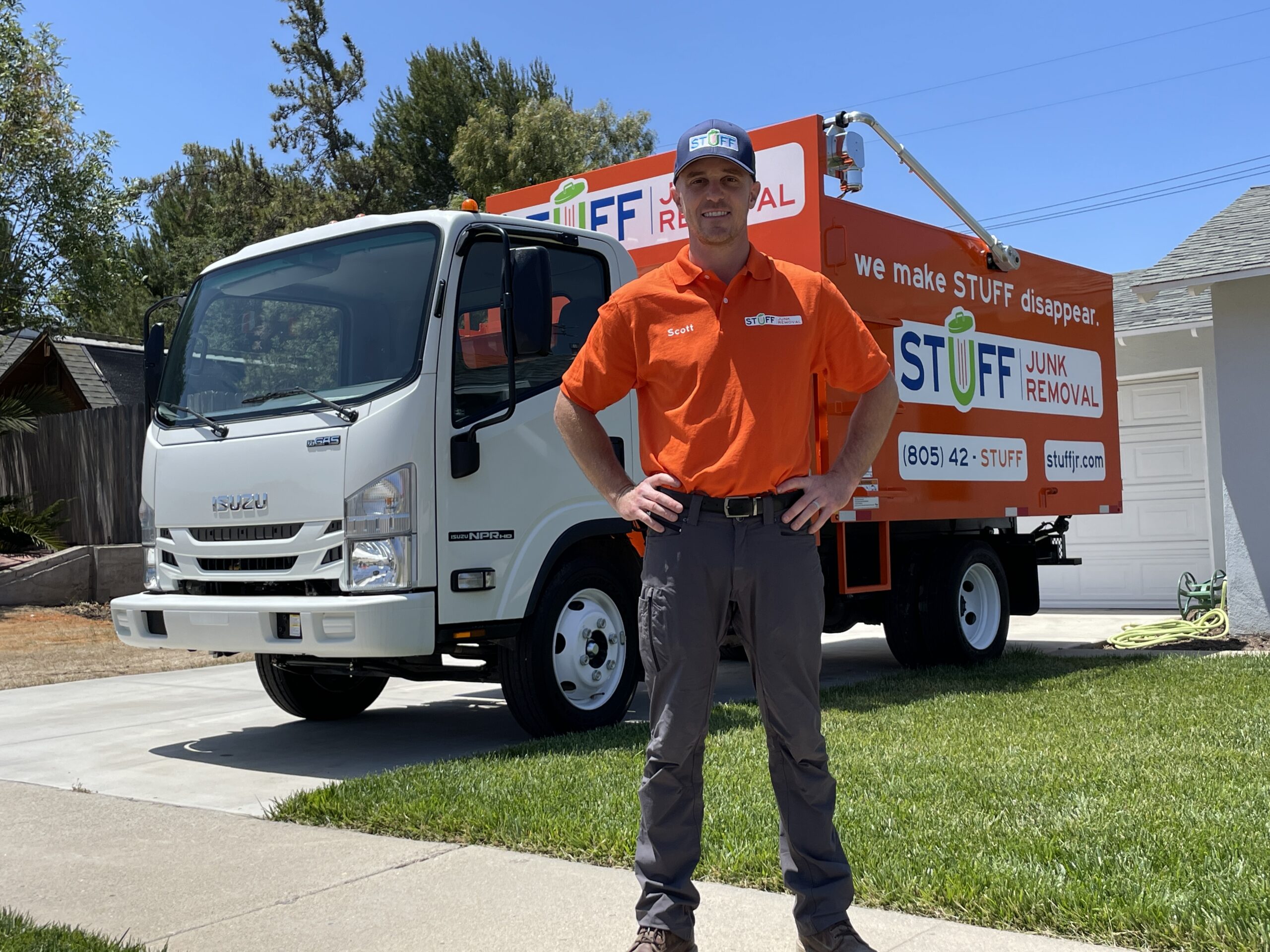 Scott Patterson, owner of STUFF Junk Removal, with the orange STUFF truck